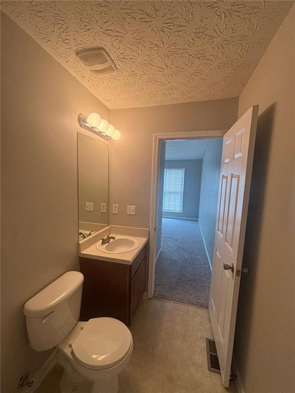 6242 Redan Overlook Lithonia, GA 30058 - Photo 14 of 17 a bathroom with a toilet sink and mirror