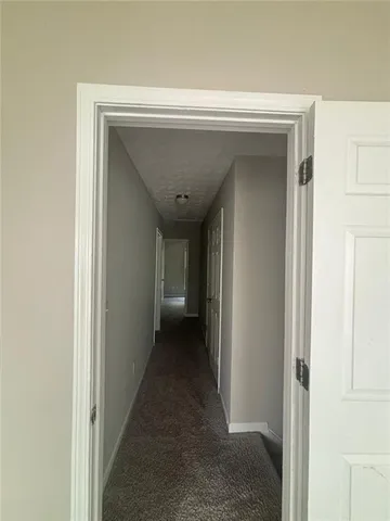a view of a hallway with wooden shelves