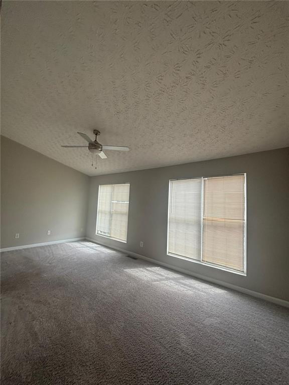 6242 Redan Overlook Lithonia, GA 30058 - Photo 3 of 17 an empty room with windows and ceiling fan view