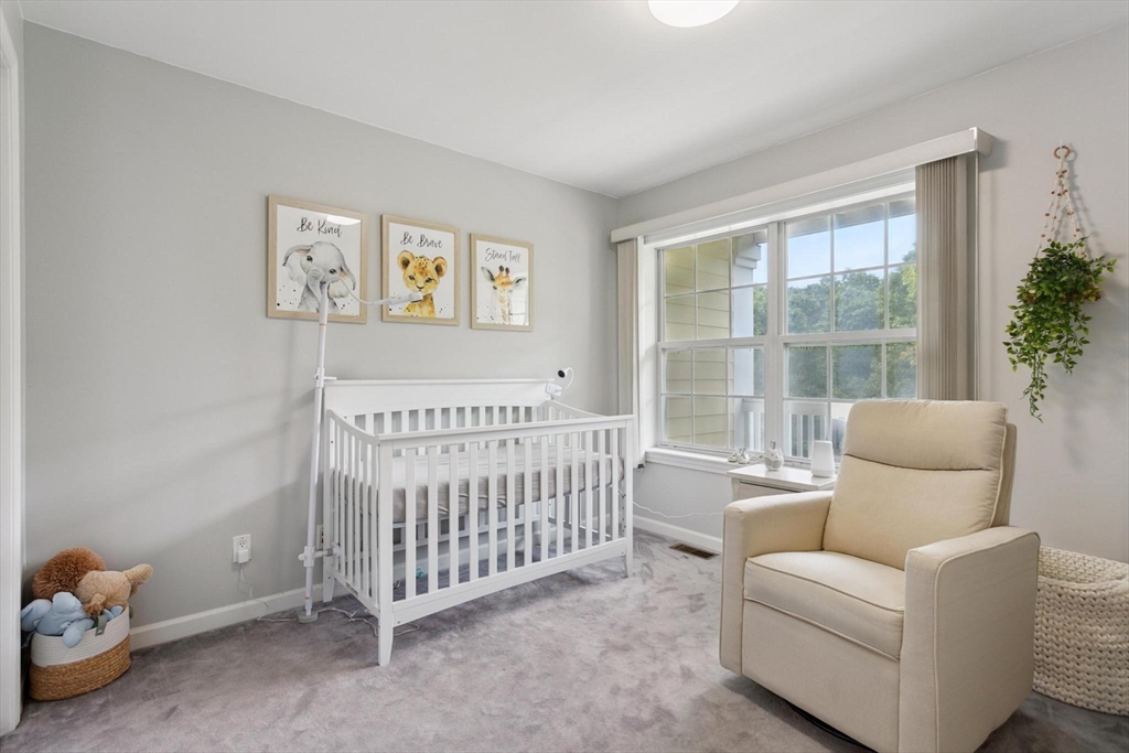 707 Gazebo Circle, Unit 707 Reading, MA 01867 - Photo 15 of 41 a bedroom with furniture and a window