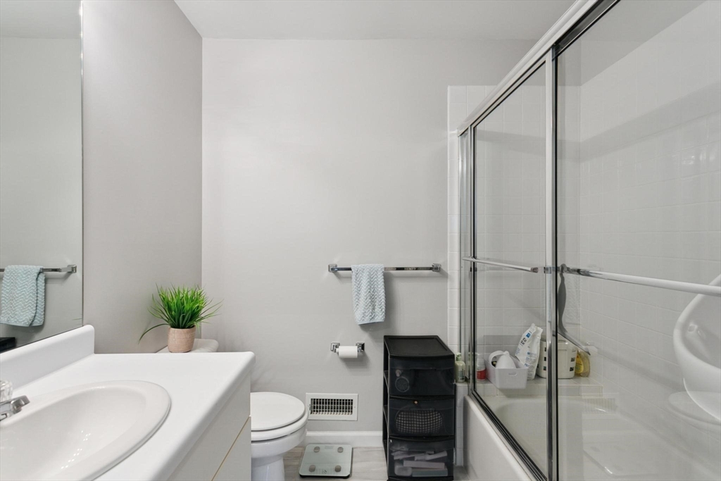 707 Gazebo Circle, Unit 707 Reading, MA 01867 - Photo 18 of 41 a bathroom with a granite countertop sink a toilet and shower