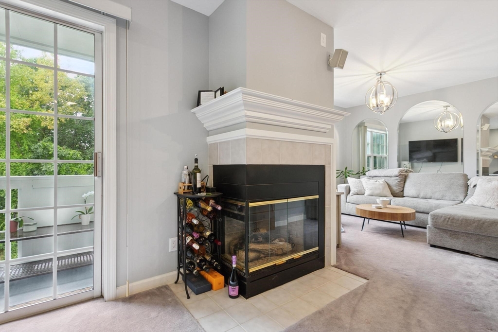 707 Gazebo Circle, Unit 707 Reading, MA 01867 - Photo 4 of 41 a living room with furniture and a fireplace