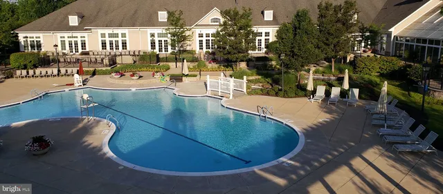 a view of a swimming pool with outdoor seating