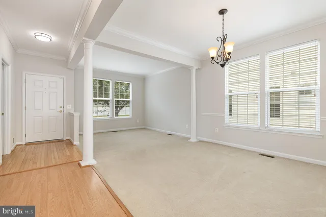 an empty room with windows and cabinet