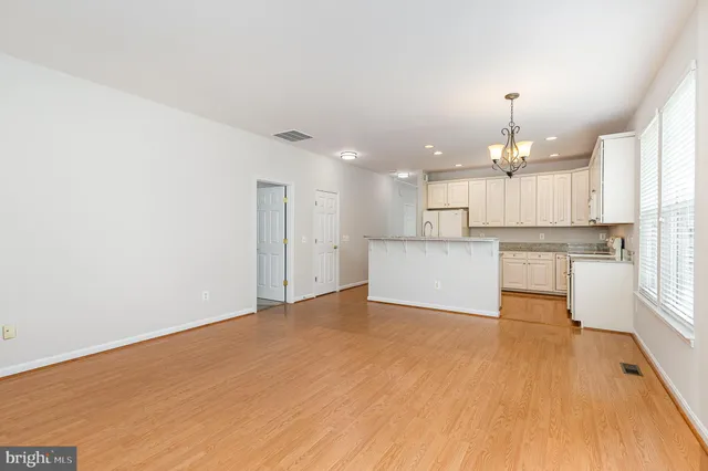 a view of a kitchen with a stove cabinets and wooden floor