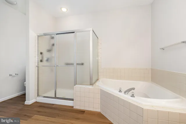 a bathroom with a tub a double vanity sink and mirror