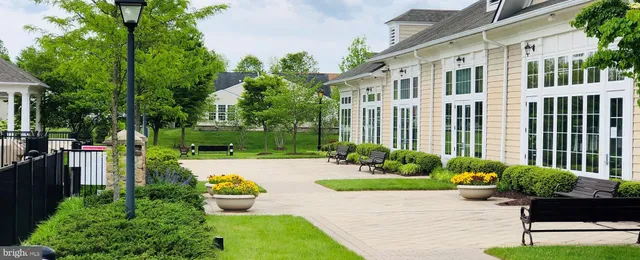 a view of a house with backyard sitting area and garden