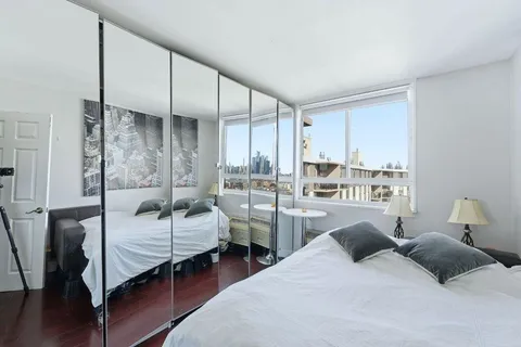 a bedroom with two beds and large window