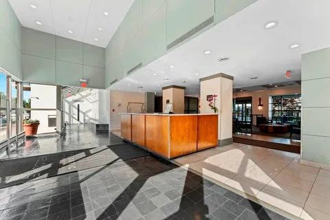 a lobby with furniture and window