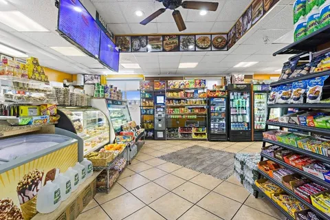 a living room with furniture a counter space and a dining table