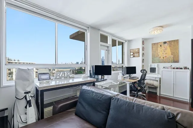 a living room with furniture and large window