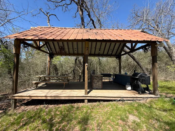 a backyard of a house with table and chairs