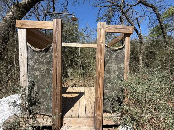 a view of a door of the house with a tree