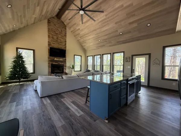 a large kitchen with stainless steel appliances granite countertop a stove and a refrigerator