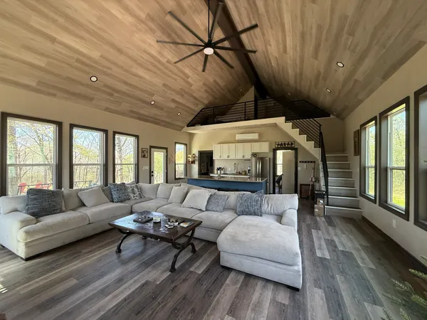 a bedroom with a bed and large windows