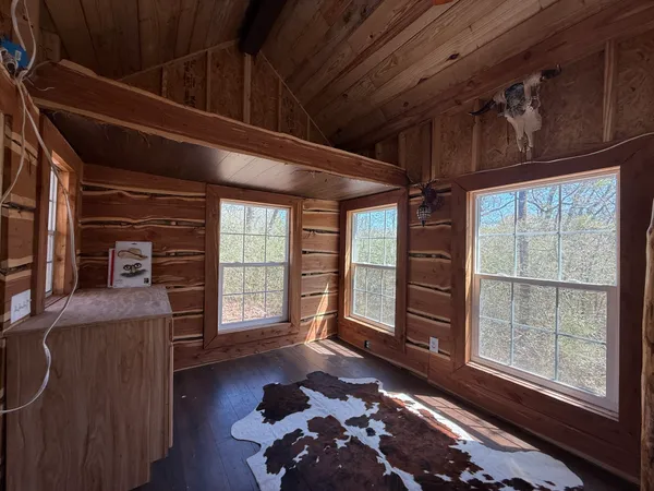 a bed room with a bed and a large window