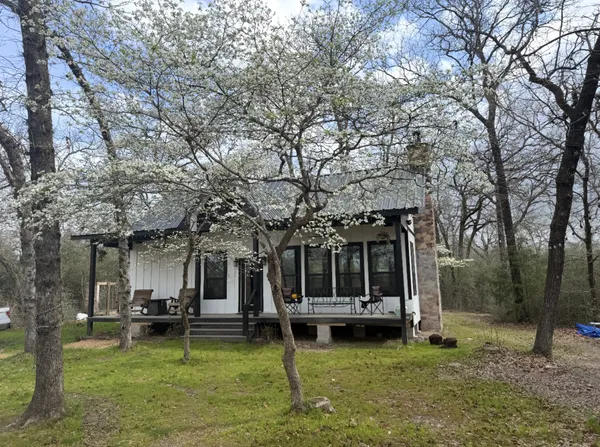 a view of a house with backyard porch and sitting area