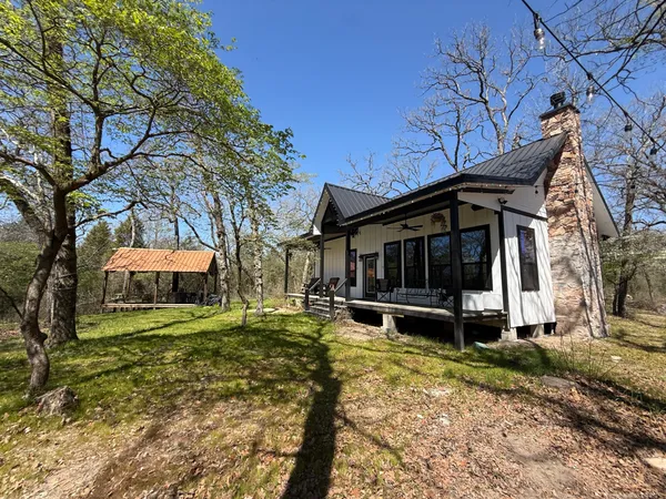 a view of a house with a yard and sitting area