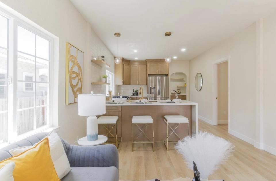 735 Locust Street San Jose, CA 95110 - Photo 6 of 21 a living room with stainless steel appliances furniture a rug and a large window
