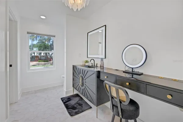 a living room with furniture and a dining table with kitchen view