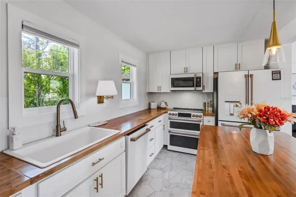 a bathroom with a granite countertop sink a toilet and shower