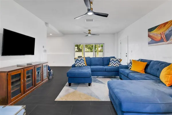 a living room with furniture and a flat screen tv
