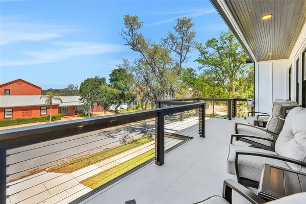 a front view of house with yard and trees in the background