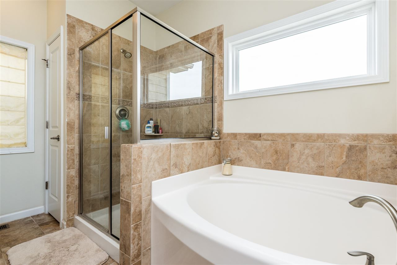 1413 Van Page Boulevard Raleigh, NC 27607 - Photo 15 of 25 MASTER BATH INCLUDES GARDEN TUB AND SEPARATE GLASS SHOWER WITH BEAUTIFUL NATURAL LIGHT. MASTER BATH