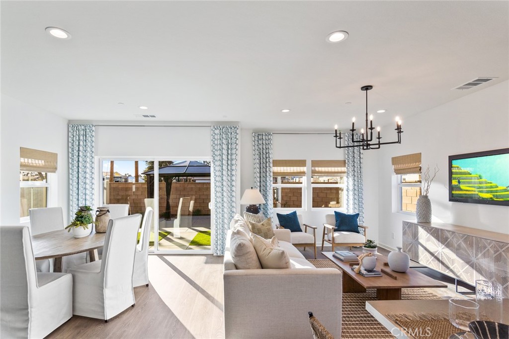 12352 Van Gogh Place Yucaipa, CA 92399 - Photo 11 of 44 a living room with furniture and a chandelier