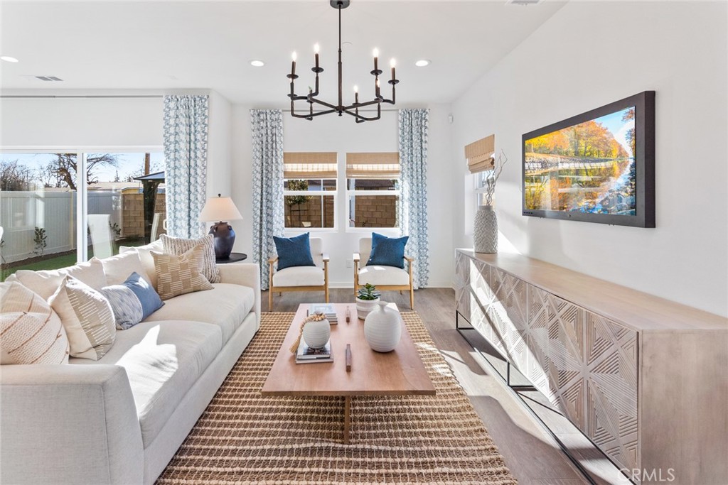 12352 Van Gogh Place Yucaipa, CA 92399 - Photo 15 of 44 a living room with furniture a rug and a chandelier