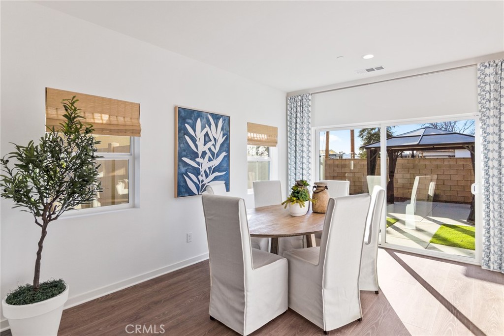 12352 Van Gogh Place Yucaipa, CA 92399 - Photo 3 of 44 a dining room with furniture and wooden floor