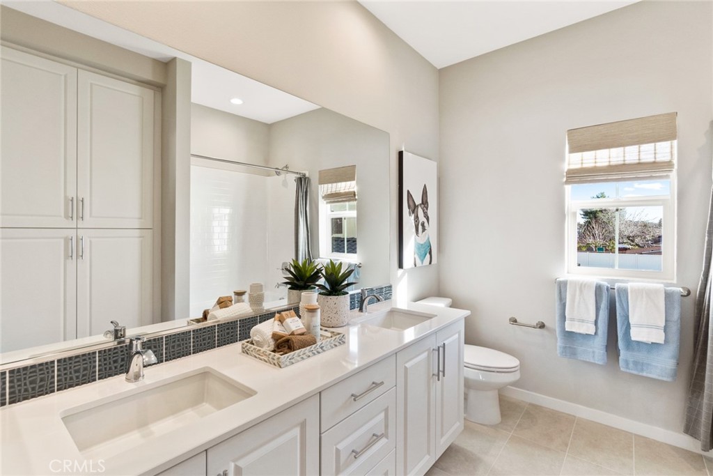12352 Van Gogh Place Yucaipa, CA 92399 - Photo 32 of 44 a bathroom with a double vanity sink toilet and a tub
