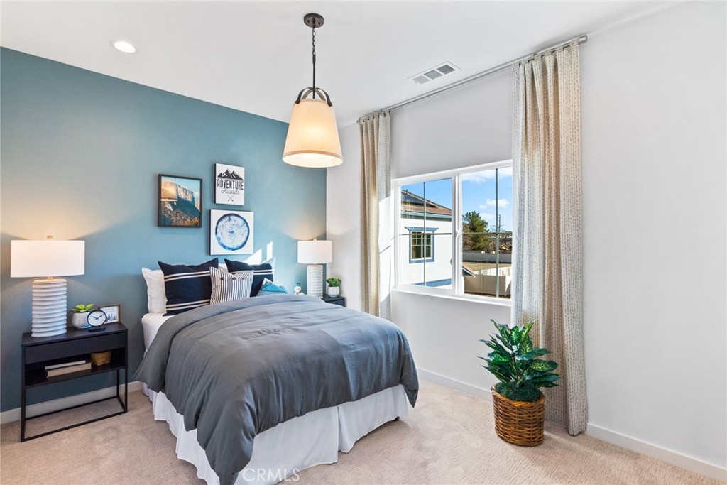 12352 Van Gogh Place Yucaipa, CA 92399 - Photo 33 of 44 a spacious bedroom with a bed and a potted plant