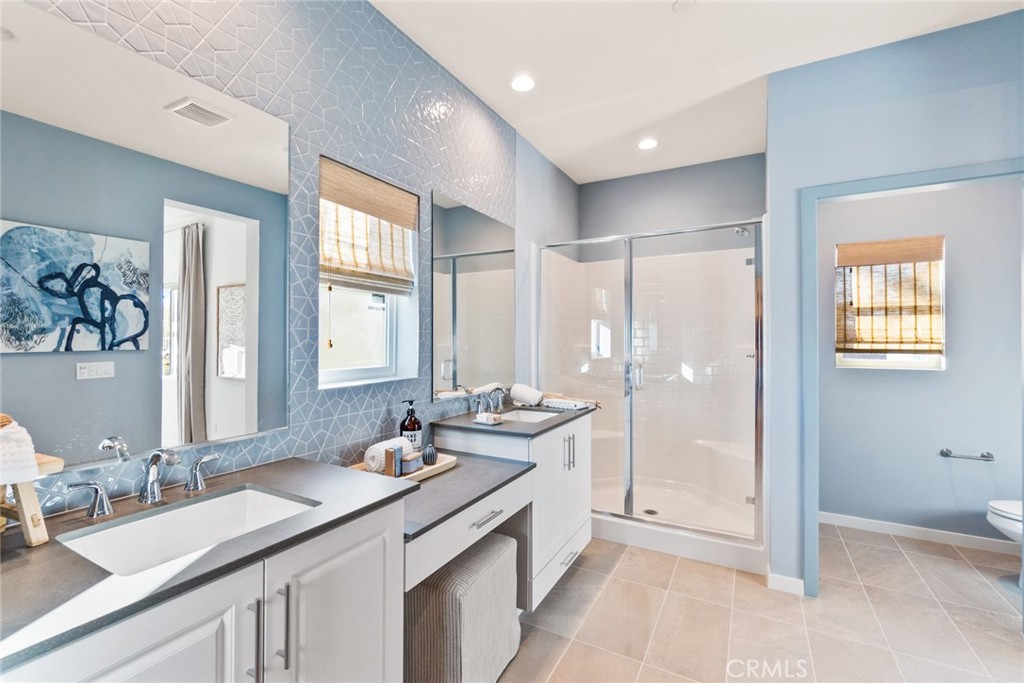 12352 Van Gogh Place Yucaipa, CA 92399 - Photo 41 of 44 a bathroom with double vanity sinks double vanity and a shower