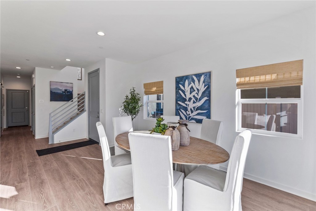 12352 Van Gogh Place Yucaipa, CA 92399 - Photo 6 of 44 a view of a dining room with furniture and wooden floor
