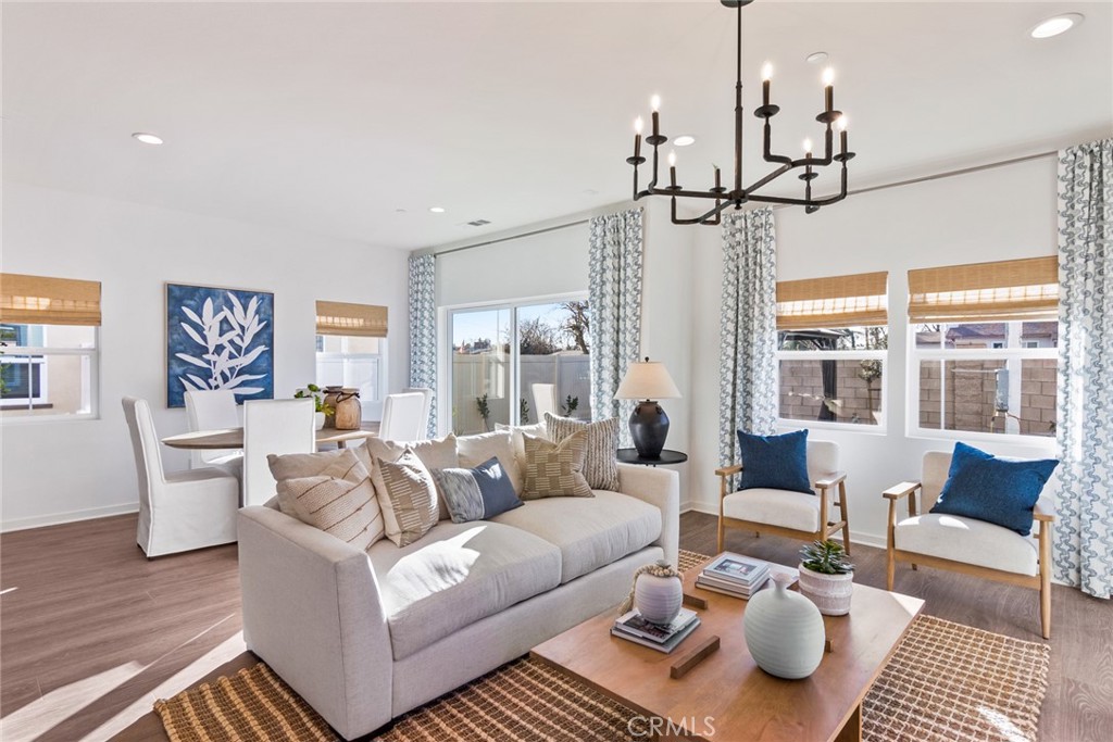 12352 Van Gogh Place Yucaipa, CA 92399 - Photo 8 of 44 a living room with furniture and a chandelier