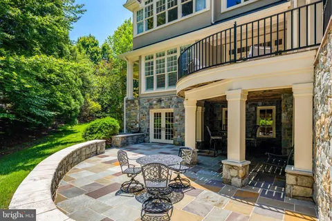 a view of a house with backyard sitting area and garden