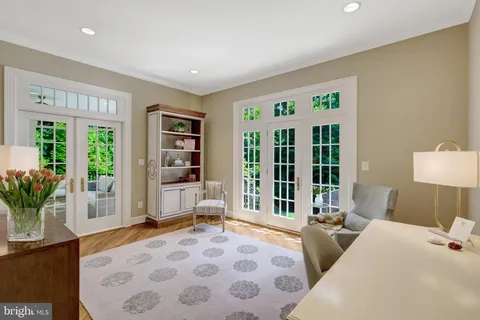 a bedroom with furniture and large windows