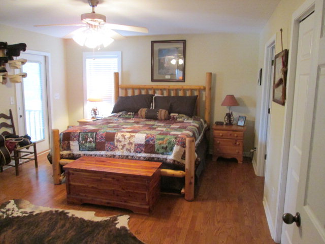 201 Dye Road Gray, GA 31032 - Photo 15 of 20 a bedroom with a bed and a chandelier