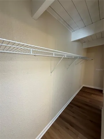 a view of a room with wooden floor