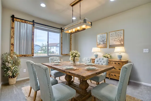 a view of a dining room with furniture window and wooden floor