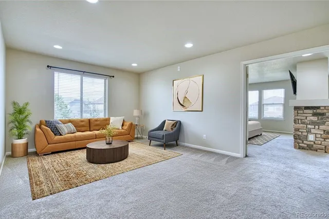 a living room with furniture and a potted plant