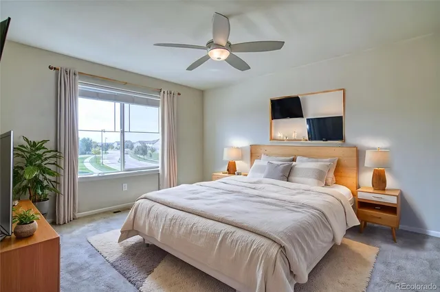 a bedroom with a large bed and a window