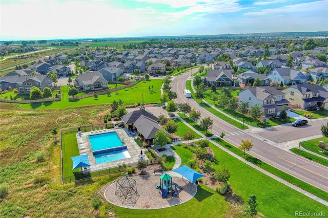 an aerial view of a house with a garden and lake view
