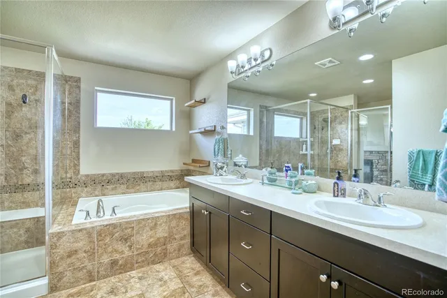 a bathroom with a tub sink and mirror