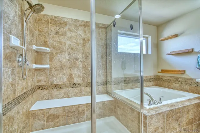 a bathroom with a bathtub and a shower