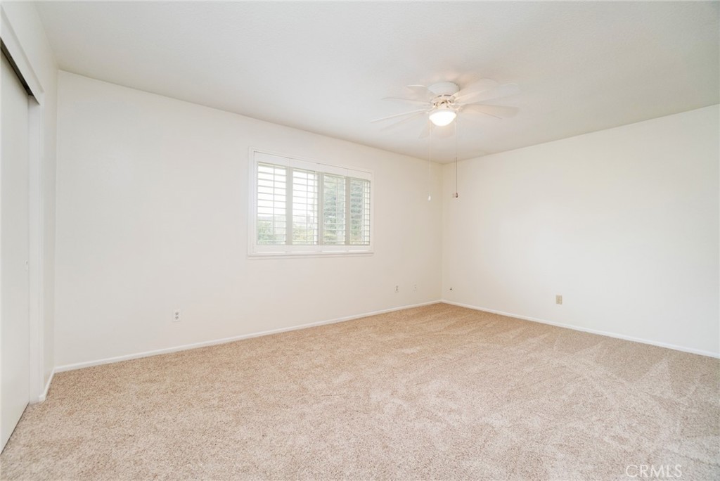 7210 Mesada Street Rancho Cucamonga, CA 91701 - Photo 17 of 32 an empty room with a chandelier fan and windows