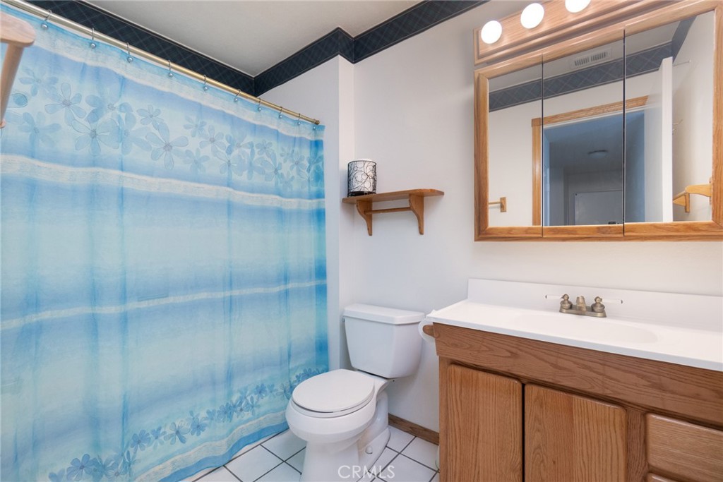 7210 Mesada Street Rancho Cucamonga, CA 91701 - Photo 21 of 32 a bathroom with a sink a toilet and shower