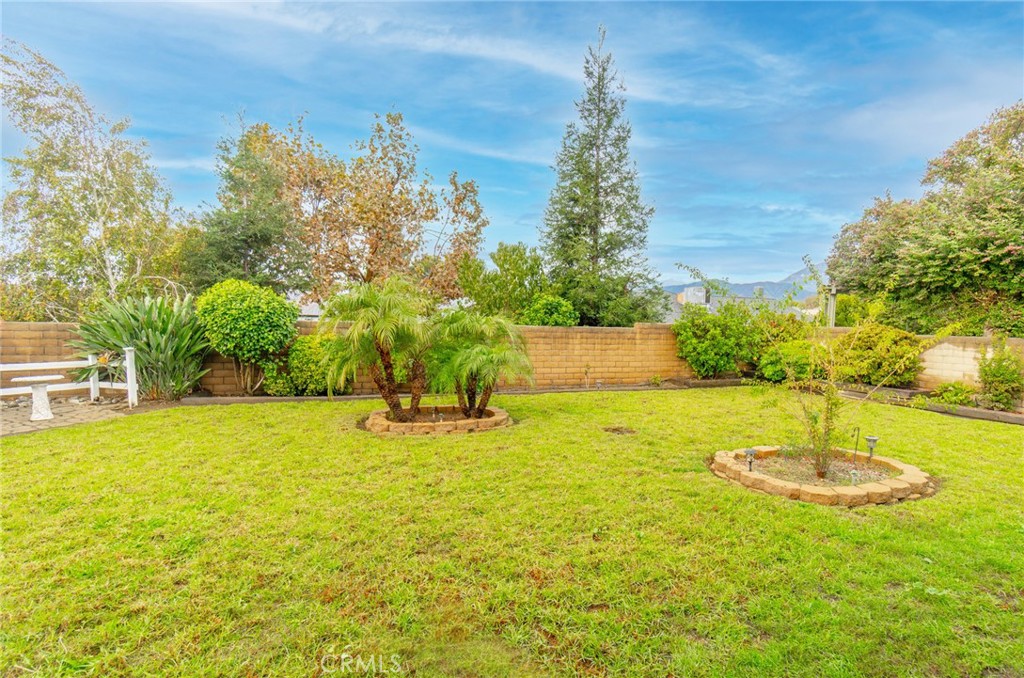 7210 Mesada Street Rancho Cucamonga, CA 91701 - Photo 30 of 32 a swimming pool with some trees in the background