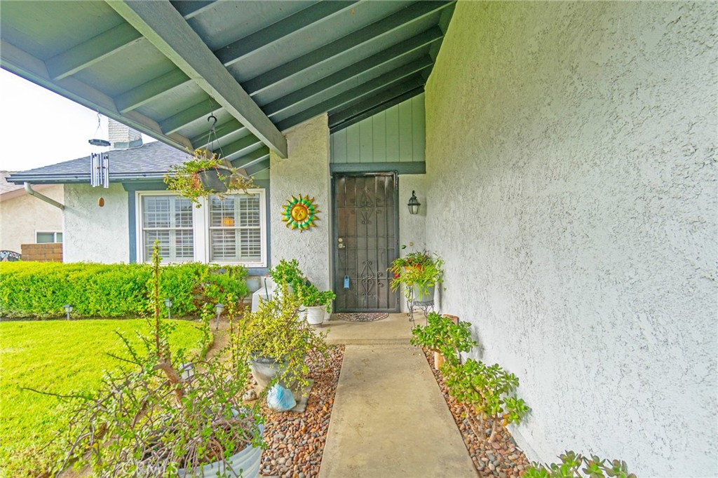 7210 Mesada Street Rancho Cucamonga, CA 91701 - Photo 10 of 32 a view of house with wooden floor and potted plants